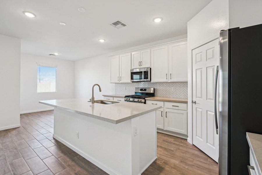 Kitchen and dining. Not actual home, finishes and options may vary.