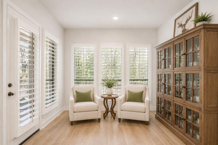 This bright breakfast room features large windows with plantation shutters, allowing plenty of natural light and the light wood flooring enhances the airy feel. Through that door is your backyard retreat. This bright breakfast room features large windows with plantation shutters, allowing plenty of natural light and the light wood flooring enhances the airy feel. Through that door is your backyard retreat.