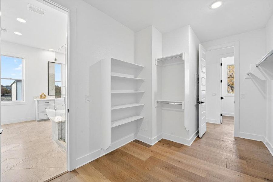 Spacious closet featuring light wood-style floors