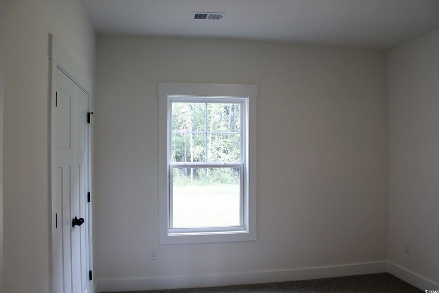 Spare room with baseboards and carpet floors