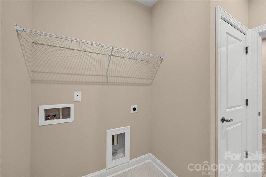 Laundry room with access to the primary closet Laundry room with access to the primary closet
