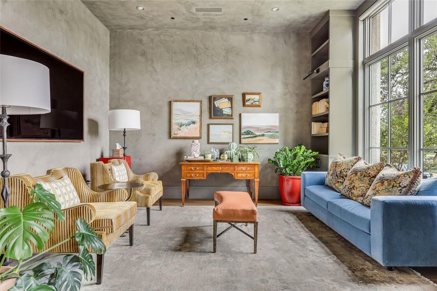 High ceilings, recessed lighting, and expansive windows define this well-appointed office or flex room.