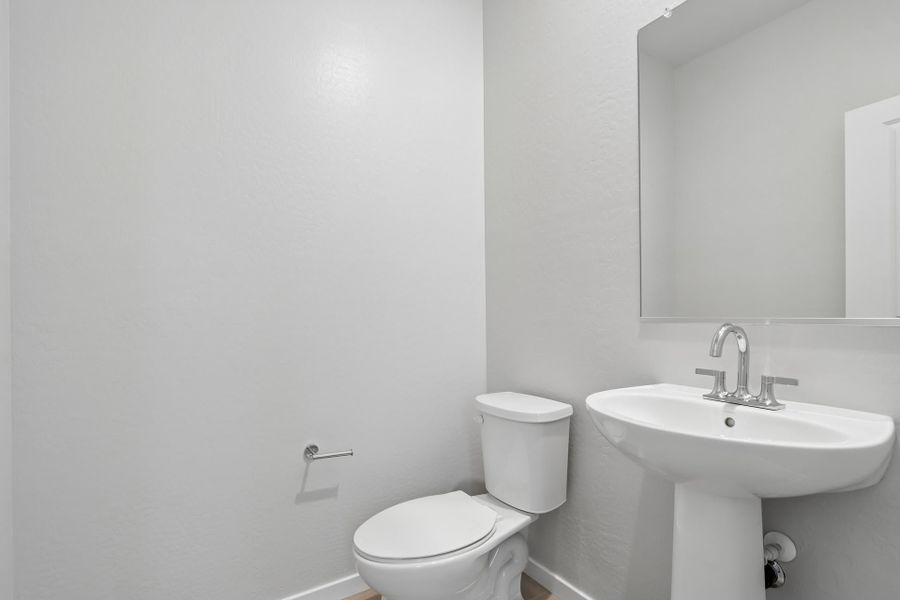 A bathroom with a toilet and sink.
