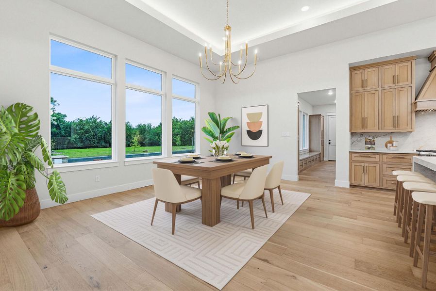 Open-concept dining area featuring expansive windows, wood-finish flooring, and a contemporary chandelier