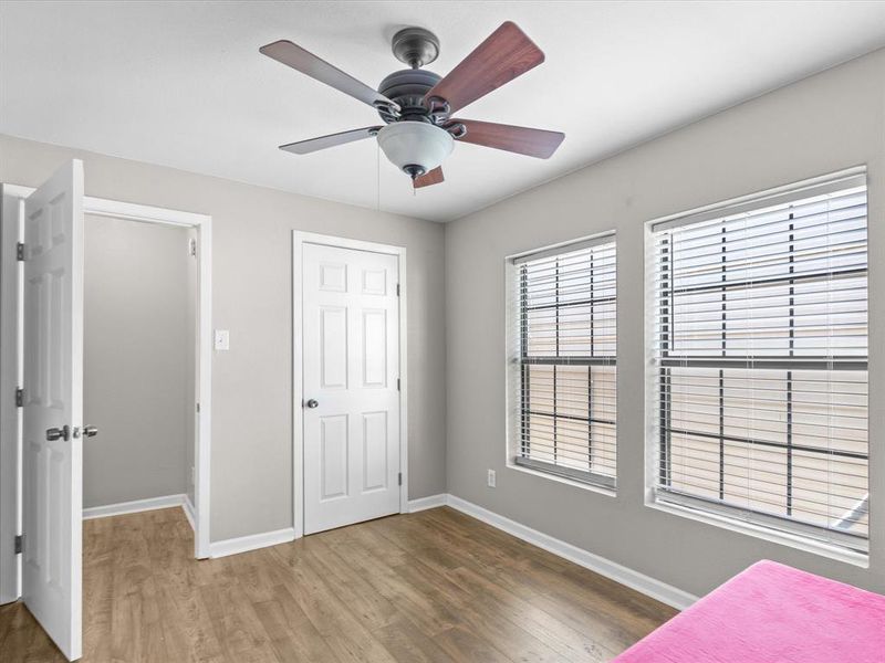 Unfurnished bedroom with wood finished floors and a ceiling fan Unfurnished bedroom with wood finished floors and a ceiling fan