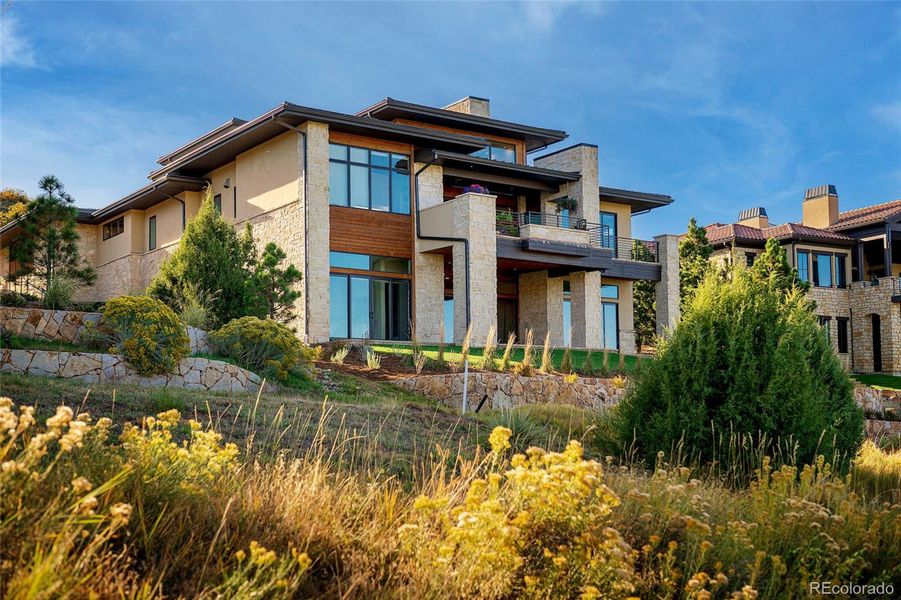 Cascading patios and decks and a recent $100,000 investment into the back landscaping provide a series of outdoor living and entertaining zones that embrace the breathtaking natural surroundings.