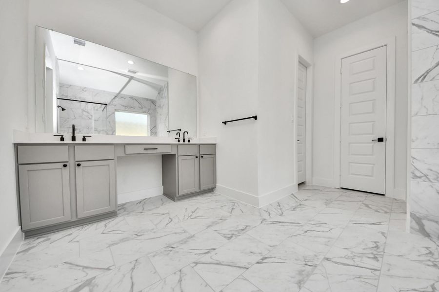 Elevate your daily routine at the elegant vanity, now equipped with double sinks, light countertops, modern hardware, and beautiful recessed lights. Elevate your daily routine at the elegant vanity, now equipped with double sinks, light countertops, modern hardware, and beautiful recessed lights.