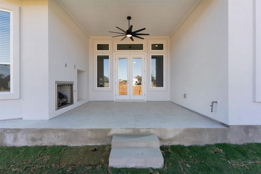 View of patio with ceiling fan and french doors
