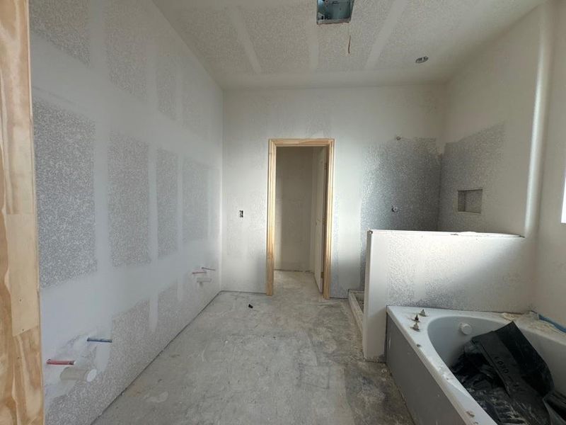 Full bathroom featuring a garden tub and a stall shower Full bathroom featuring a garden tub and a stall shower