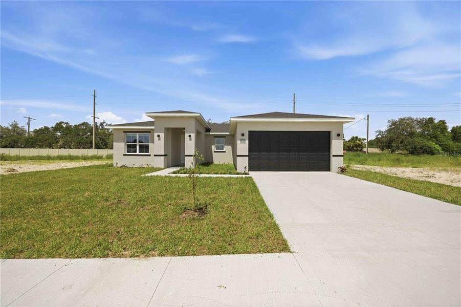 Front exterior of a new home in , Winter Haven, FL, highlighting curb appeal (Image 2).