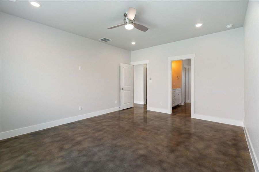 This angle of the primary bedroom displays the entryway and en-suite bathroom. This angle of the primary bedroom displays the entryway and en-suite bathroom.
