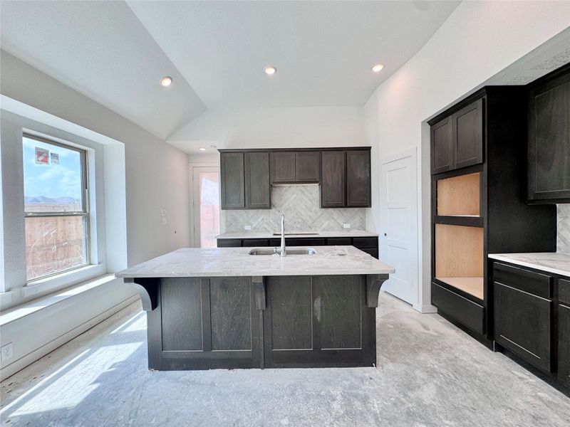 Smokey grey brown (Grey Wolf) Kent Moore cabinets with beautiful counter and backsplash to compliment the moody vibe!
