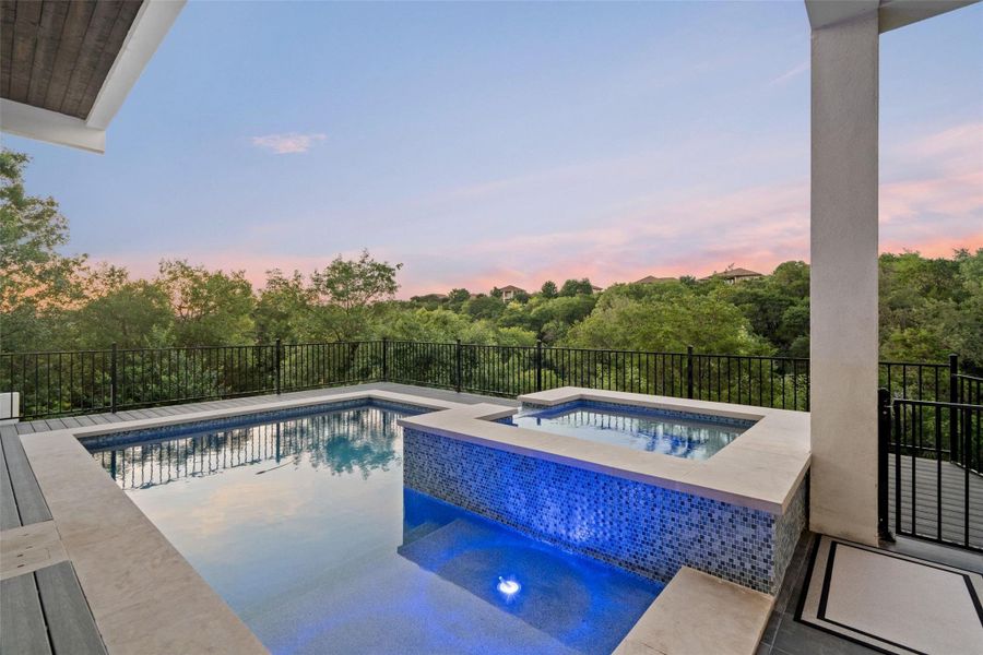 Outdoors, multiple covered terraces invite year-round enjoyment with a resort-style pool and spa, summer kitchen, firepit, and sweeping canyon views.