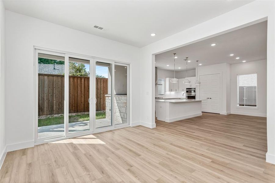 Unfurnished living room with recessed lighting, healthy amount of natural light, and light wood-style flooring