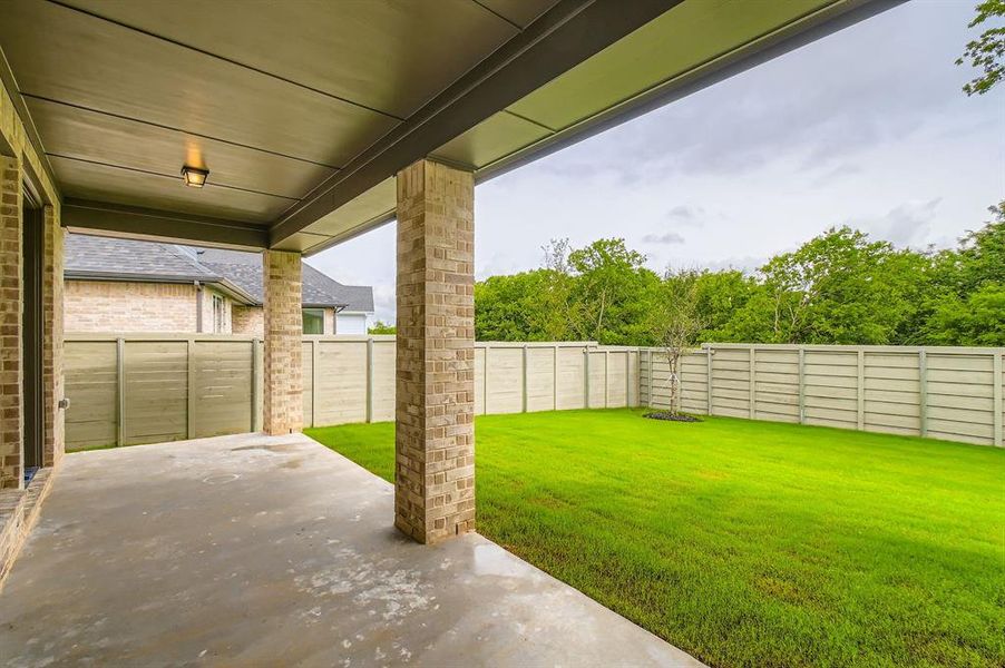 Fenced backyard featuring a patio area Fenced backyard featuring a patio area