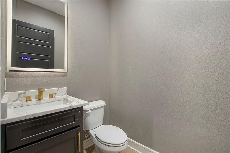 1/2 Bathroom with vanity and toilet