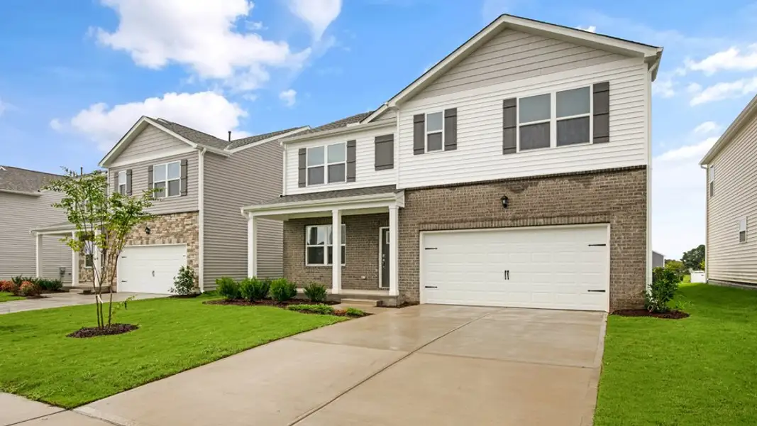 Front exterior of a new home in The Reserve at Prestleigh, Wake Forest, NC, highlighting curb appeal (Image 2). Front exterior of a new home in The Reserve at Prestleigh, Wake Forest, NC, highlighting curb appeal (Image 2).