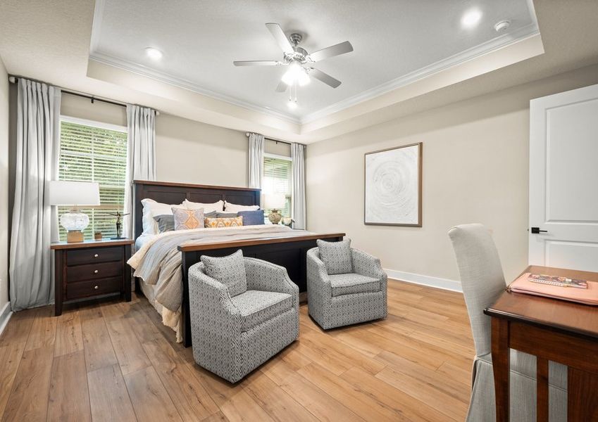 Master bedroom with wood and ceiling fan.