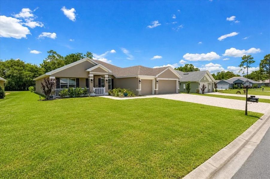Front exterior of a new home in Juliette Falls, Dunnellon, FL, highlighting curb appeal (Image 25). Front exterior of a new home in Juliette Falls, Dunnellon, FL, highlighting curb appeal (Image 25).