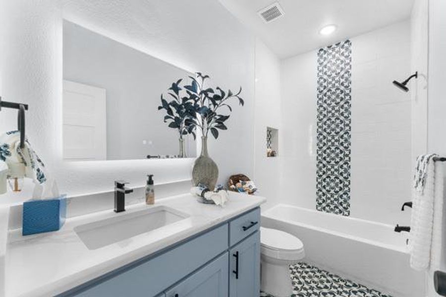 Bathroom with washtub / shower combination, vanity, and tile patterned floors Bathroom with washtub / shower combination, vanity, and tile patterned floors