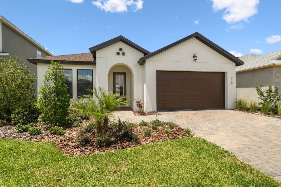 Front exterior of a new home in Avalon West, Spring Hill, FL, highlighting curb appeal (Image 3).