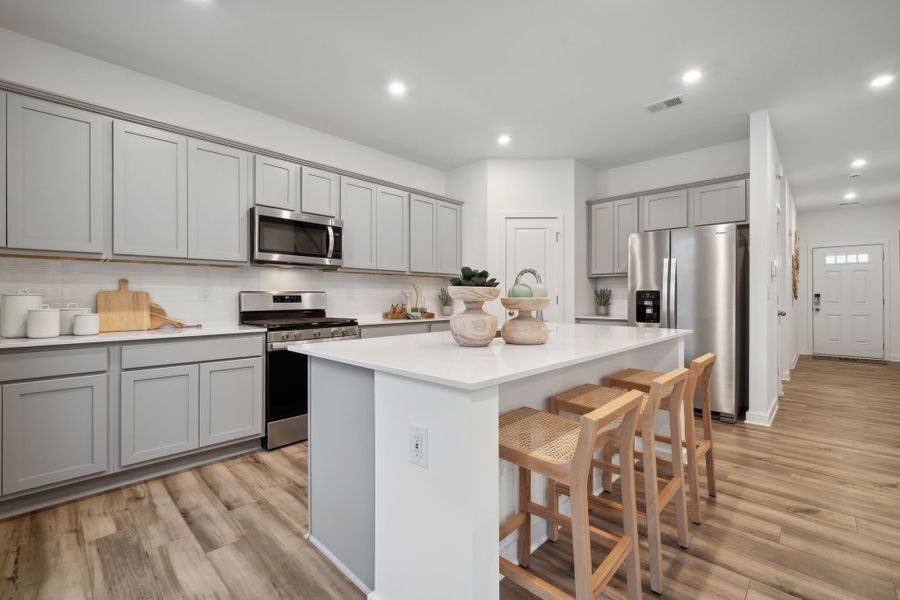 A kitchen with white cabinets.