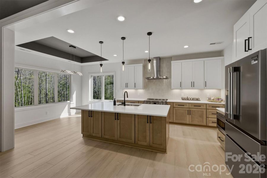 From there our attention moves into the kitchen. Notice the pendant lights over the large island with room for bar stools and some under counter storage. From there our attention moves into the kitchen. Notice the pendant lights over the large island with room for bar stools and some under counter storage.