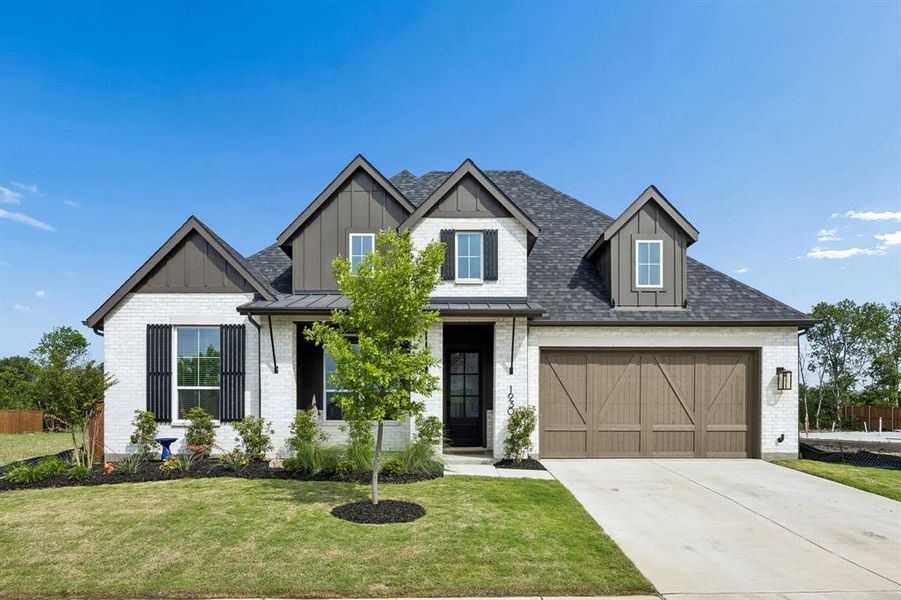 Contemporary farmhouse exterior featuring white brick, dark board-and-batten gables, a dark asphalt shingle roof, a wood-finish garage door, and black window shutters Contemporary farmhouse exterior featuring white brick, dark board-and-batten gables, a dark asphalt shingle roof, a wood-finish garage door, and black window shutters
