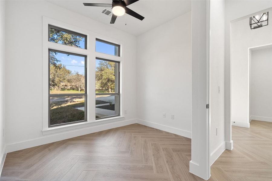 Unfurnished room featuring baseboards and ceiling fan