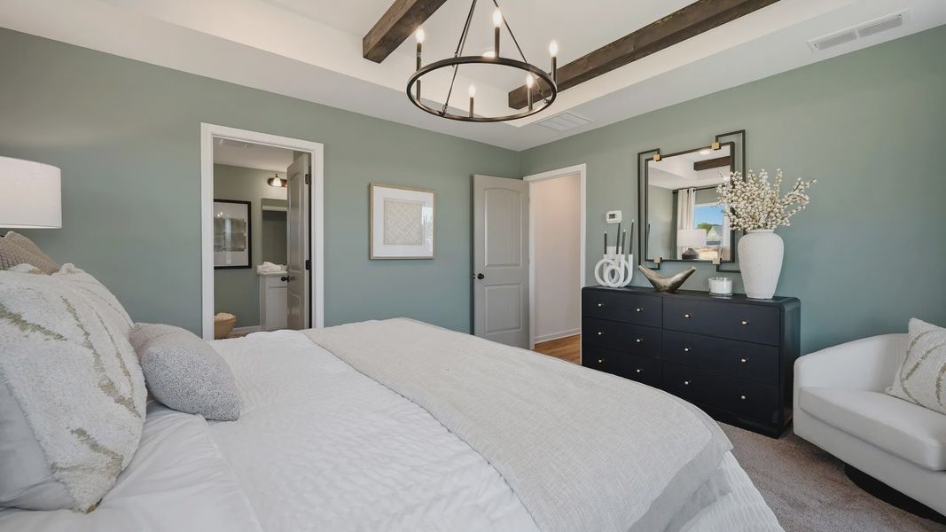 Primary bedroom featuring elegant tray ceiling in new construction townhome at Langley Overlook in Loganville, GA. Primary bedroom featuring elegant tray ceiling in new construction townhome at Langley Overlook in Loganville, GA.