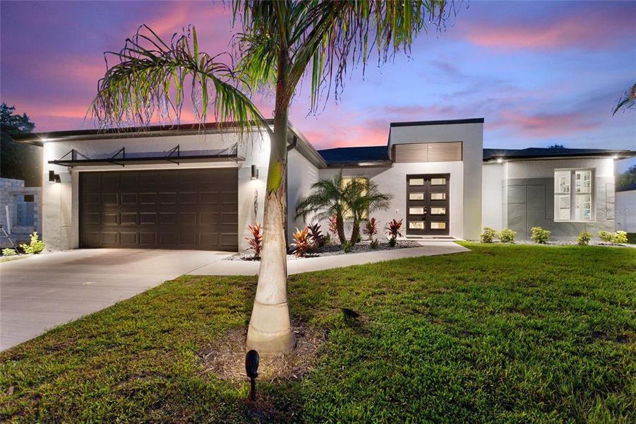 Front exterior of a new home in , Punta Gorda, FL, highlighting curb appeal (Image 1).