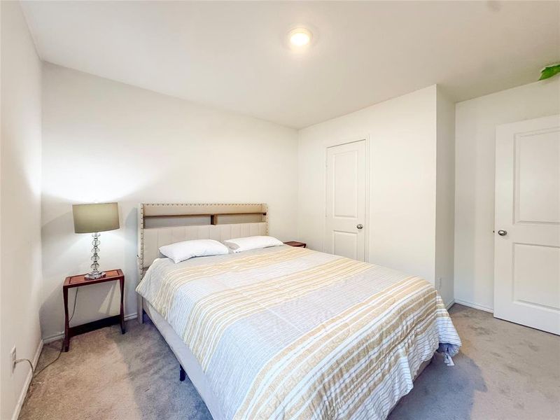Bedroom with light carpet