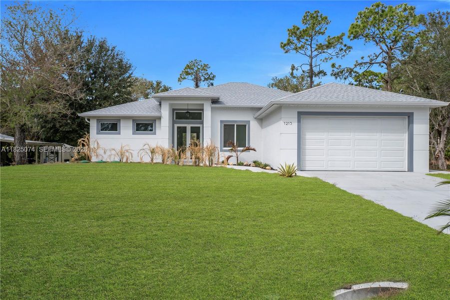 Front exterior of a new home in , Lehigh Acres, FL, highlighting curb appeal (Image 22).