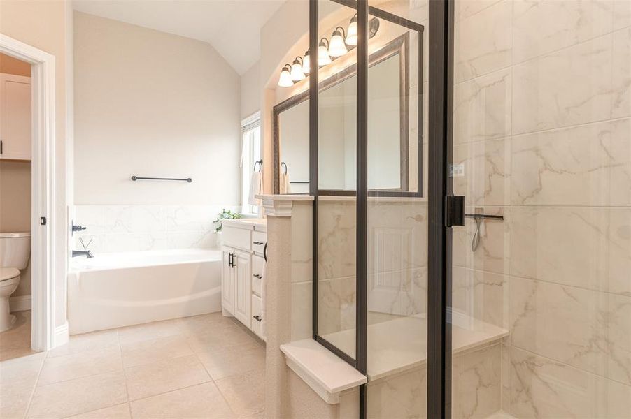Primary Bathroom with separate soaker tub and tile shower