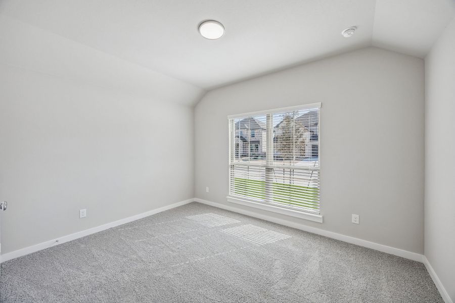 Bedroom in the Heisman home plan by Trophy Signature Homes – REPRESENTATIVE PHOTO