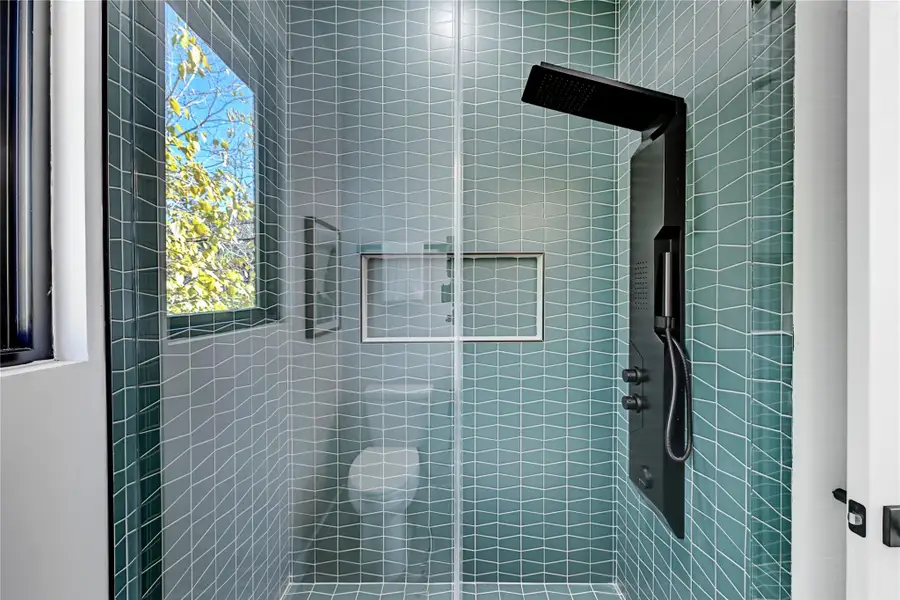 Bathroom featuring tiled shower