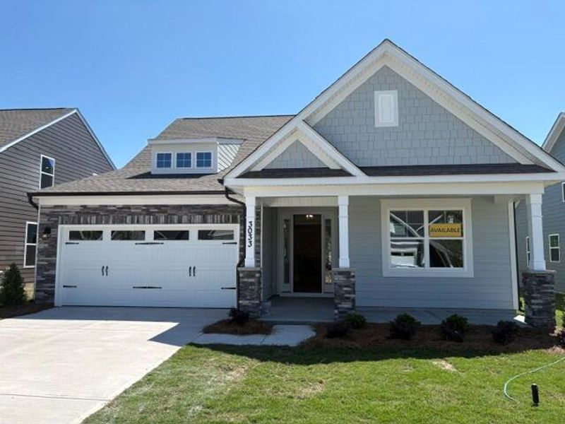 Front exterior of a new home in Heritage - 55+ Community, Indian Trail, NC, highlighting curb appeal (Image 1). Front exterior of a new home in Heritage - 55+ Community, Indian Trail, NC, highlighting curb appeal (Image 1).