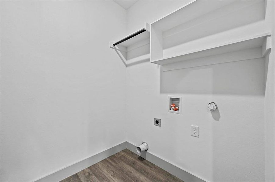 Full laundry room with a door to the back fenced yard.