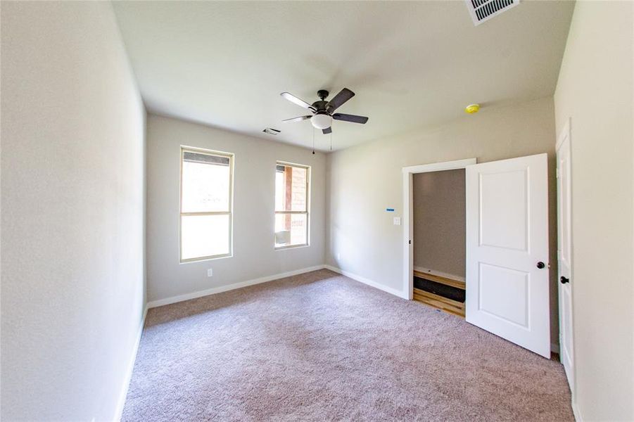 Unfurnished bedroom with carpet flooring and ceiling fan