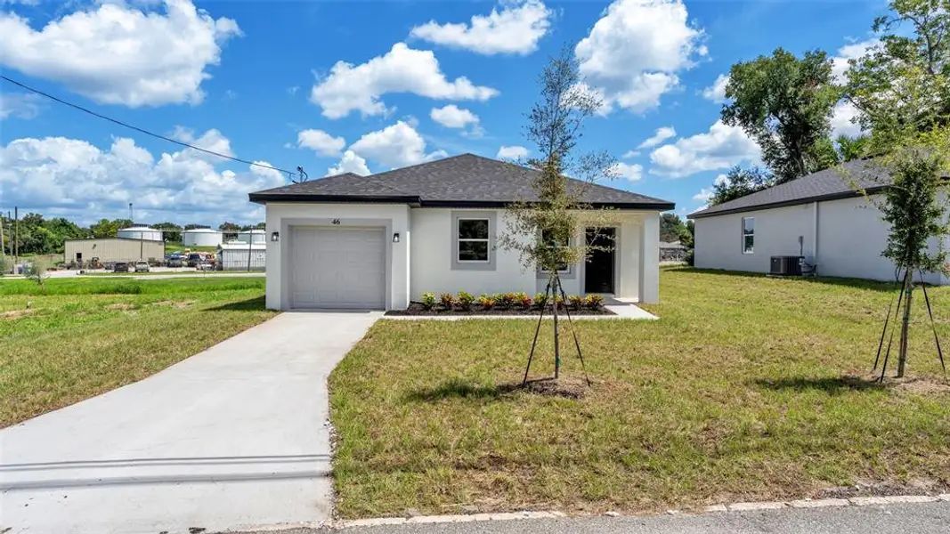 Front exterior of a new home in , Haines City, FL, highlighting curb appeal (Image 1). Front exterior of a new home in , Haines City, FL, highlighting curb appeal (Image 1).