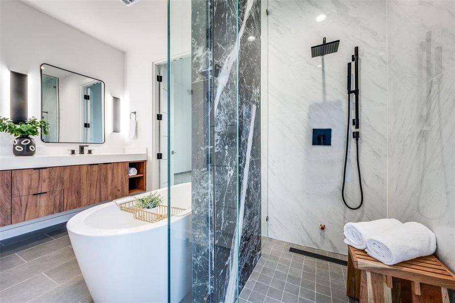 Bathroom featuring a marble finish shower, tile patterned flooring, a freestanding bath, and vanity Bathroom featuring a marble finish shower, tile patterned flooring, a freestanding bath, and vanity