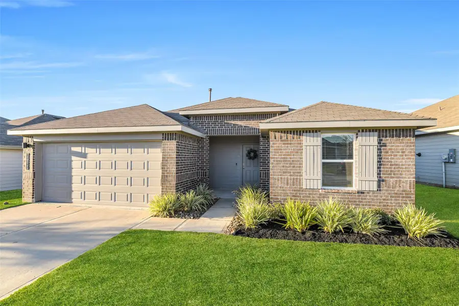 Front exterior of a new home in Summerwood Trails, Willis, TX, highlighting curb appeal (Image 2). Front exterior of a new home in Summerwood Trails, Willis, TX, highlighting curb appeal (Image 2).