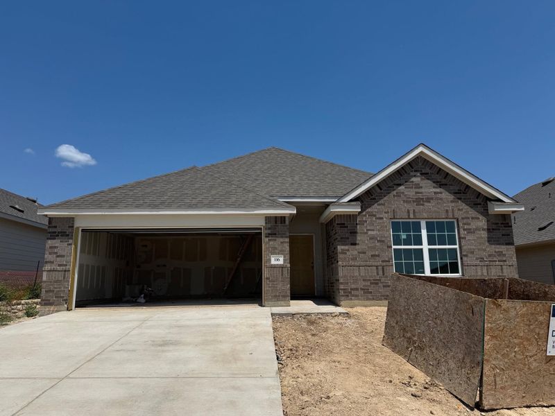 View of front of property featuring brick siding, a garage, concrete driveway, and roof with shingles