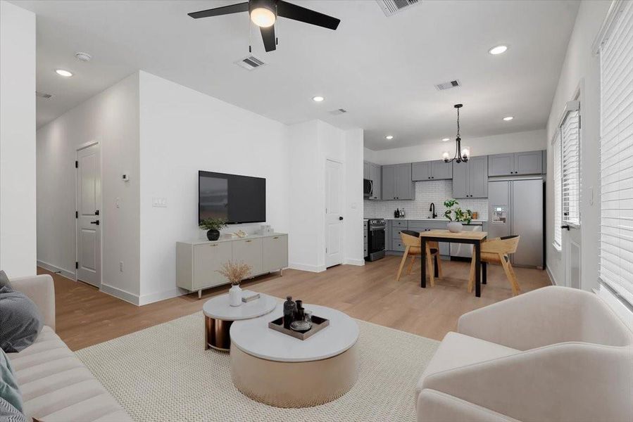 Staged-- Modern open-concept first floor featuring sleek finishes, spacious layout, and seamless flow between living, dining, and kitchen areas - ideal for everyday comfort and entertaining. Staged-- Modern open-concept first floor featuring sleek finishes, spacious layout, and seamless flow between living, dining, and kitchen areas - ideal for everyday comfort and entertaining.