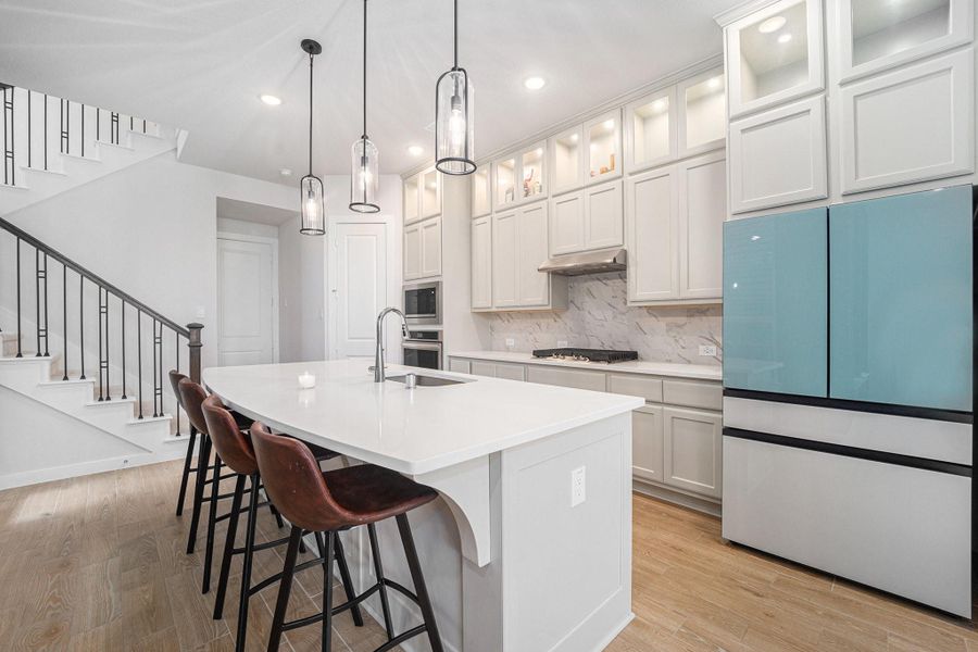 Gourmet kitchen featuring quartz countertops, gas cooktop and ample cabinetry.