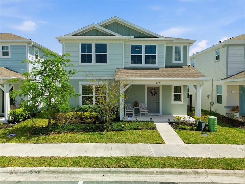 Front exterior of a new home in Winding Meadows, Apopka, FL, highlighting curb appeal (Image 24).
