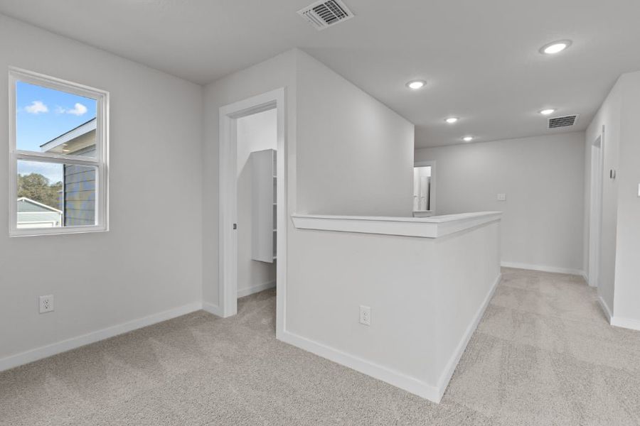 A room with a white cabinet and a window.