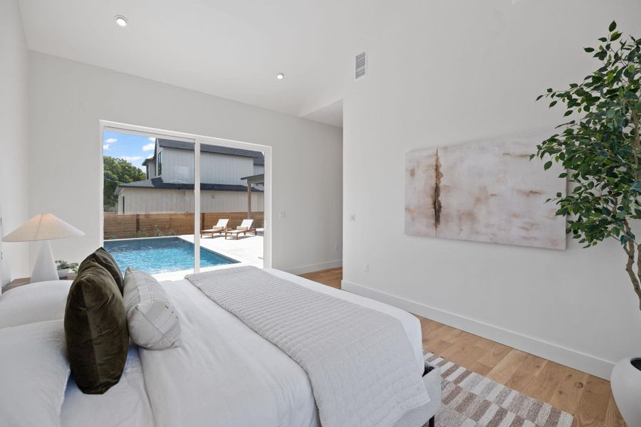 Bedroom with light wood-type flooring, access to exterior, and recessed lighting Bedroom with light wood-type flooring, access to exterior, and recessed lighting