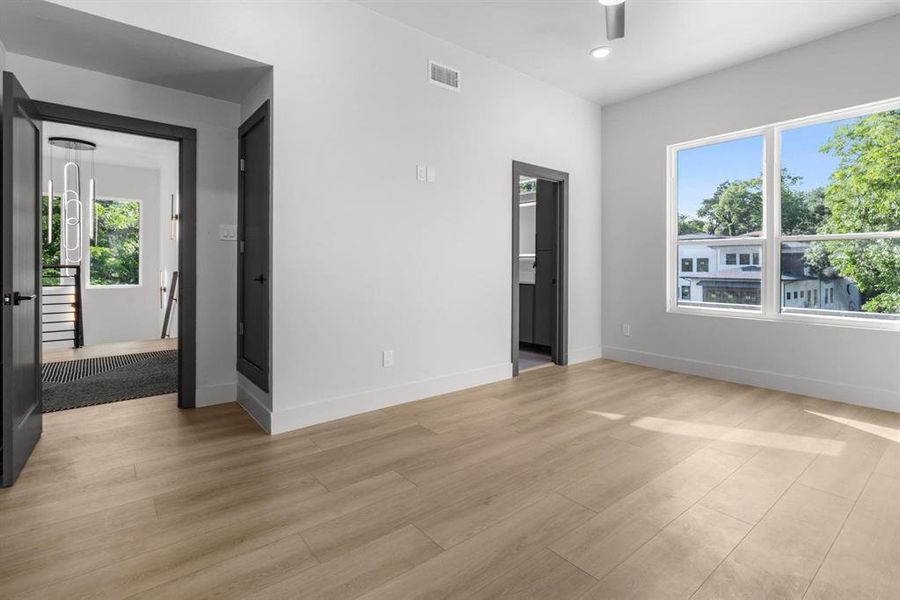 Spare room featuring healthy amount of natural light, recessed lighting, light wood finished floors, and a ceiling fan