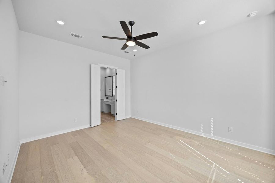 Unfurnished room with a ceiling fan, light wood finished floors, and recessed lighting Unfurnished room with a ceiling fan, light wood finished floors, and recessed lighting